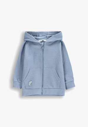 Jasnoniebieska bluza z kapturem zapinana na zamek, wykonana z teksturowanej tkaniny, z kieszenią typu kangaroo, ściągaczami przy mankietach i u dołu, z małym wyszywanym logo ryby na kieszeni.