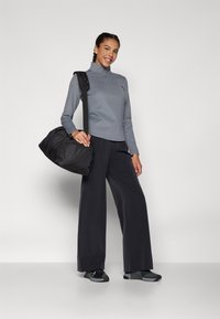 Nike Performance BLISS TROUSER - Kelnės - black