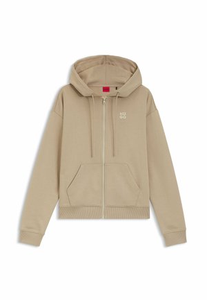 Beige Kapuzenpullover mit Reißverschluss, Fronttaschen, Kordelzug an der Kapuze, gerippten Bündchen und Saum sowie kleinem "HUGO"-Logo auf der linken Brust.