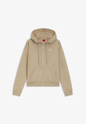 Beige Kapuzenpullover mit Reißverschluss, Fronttaschen, Kordelzug an der Kapuze, gerippten Bündchen und Saum sowie kleinem "HUGO"-Logo auf der linken Brust.
