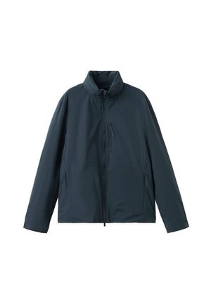 Veste légère bleu foncé avec col montant, fermeture éclair frontale, poche poitrine zippée et deux poches latérales zippées, présentée sur fond blanc.