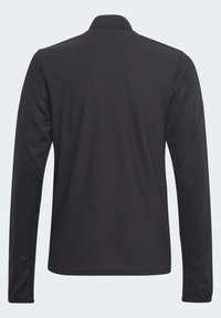 Schwarzes Langarm-Polohemd mit strukturiertem Wabenmuster, klassischem Kragen und abgerundetem Saum. Glatte Stoffqualität mit minimalen Nähten.