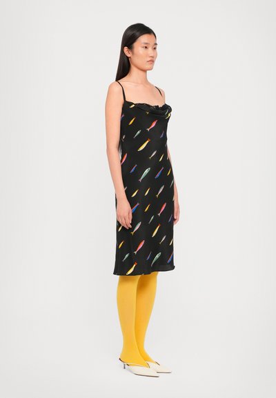 Zwarte mouwloze jurk met kleurrijke vissenpatronen, coudepunt halslijn, gecombineerd met gele panty' s en witte spitze schoenen, minimalistisch ontwerp.