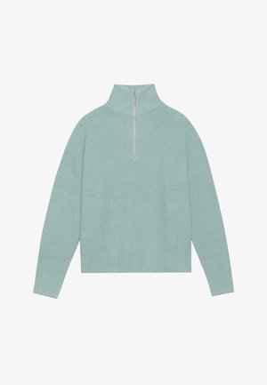 Mündroheline pullover-sviiter, mis sisaldab kõrget kraed, neljandiku pikkusega lukuga esiosa, ribakat tekstuuri ning lõtvust laia varrukatega.