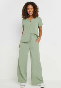 M&Co WIDE - Pantalones - light green