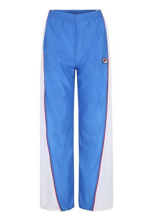 Pantalon coupe-vent bleu avec panneaux latéraux blancs, taille élastique, accents rouges et un petit logo en haut à gauche à l'avant. Matériau léger.