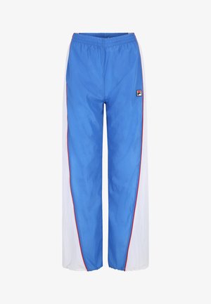 Blå vindjakke bukser med hvide sidelapper, elastisk talje, røde detaljer og et lille logo øverst til venstre foran. Letvægtsmateriale.