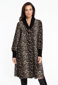 Leopardenmuster Kleid mit V-Ausschnitt und schwarzen gerippten Bündchen. Lockerer Schnitt mit knielanger Saumlinie und strukturiertem Stoff.