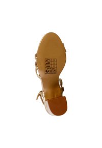 Strappy heel sandal with a metallic gold finish. Features a smooth sole, rounded toe, and adjustable ankle strap. Bottom includes size and care symbols.