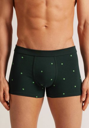 Boxershorts aus dunkelgrünem Baumwollstoff mit einem dezenten Muster kleiner grüner Quadrate. Das Design beinhaltet einen enganliegenden Bund und einen bequemen Schnitt.