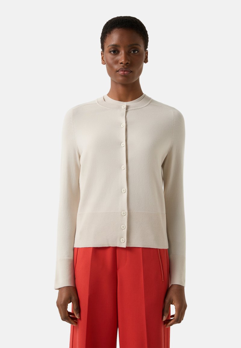 Light beige cardigan made of soft material, featuring a round neckline, full-length sleeves, and a button-down front with six buttons.
