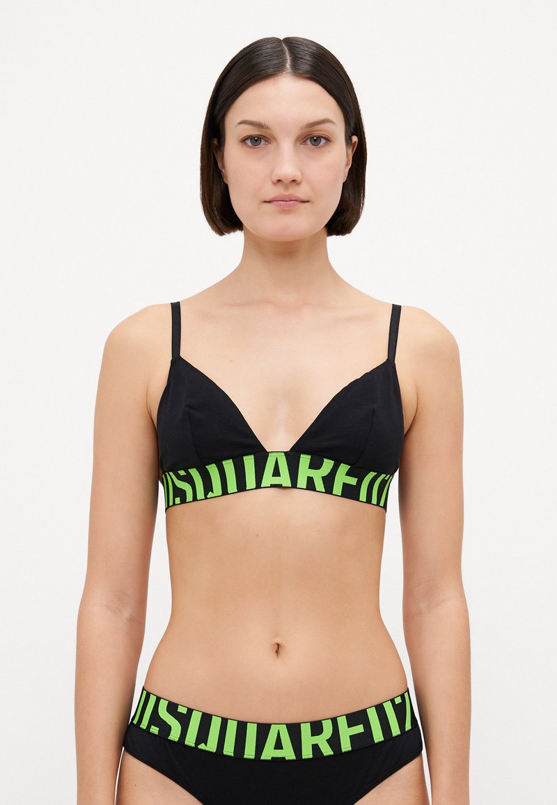 Bralette nera con spalline sottili, caratterizzata da un design a scollo a V e una fascia con logo verde neon sotto il busto. Tessuto liscio, stile minimalista.
