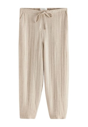 Beige linen pants with elastic waist, drawstring tie, side pockets, and straight wide legs.