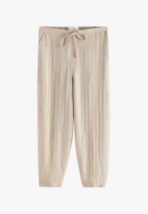 Beige linen pants with elastic waist, drawstring tie, side pockets, and straight wide legs.