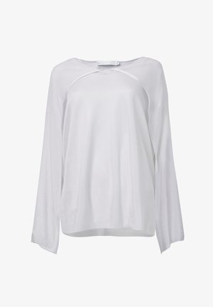 Haut à manches longues blanc en tissu léger et texturé. Doté d'un col rond et d'une coupe décontractée. Design simple et polyvalent.