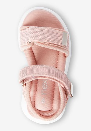 Sandalia rosa claro con tiras de tela suave y cierres ajustables de velcro, suela de goma blanca. Detalles texturizados en las tiras.