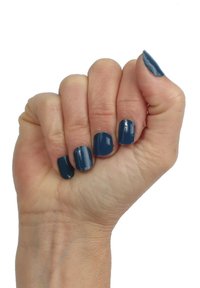 Nails painted in a deep blue glossy polish. Hand is in a fist position, revealing a smooth skin texture and natural nail shape.