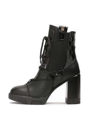 Black ankle boot with a block heel, featuring smooth leather and patent leather panels, lace-up front, and textured side accents.