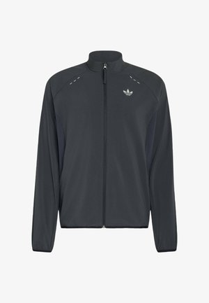 Czarna kurtka Adidas zapinana na zamek, z długimi rękawami, stójką, odblaskowymi detalami na ramionach i logo Adidas trefoil na piersi.