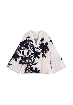 Haut à imprimé floral crème avec motifs noirs, doté d'un col en V profond et de larges manches évasées. Texture douce avec une coupe ample.