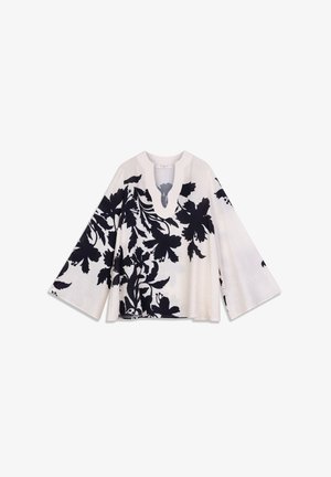 Top met bloemenprint in crèmekleur met zwarte ontwerpen, voorzien van een diepe V-hals en brede klokmouwen. Zachte textuur met een losse pasvorm.