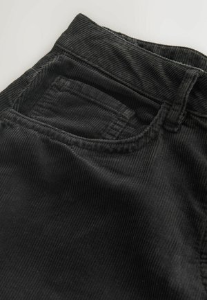 Black corduroy pants featuring horizontal ribbing, a waistband, and a small front pocket, with a soft texture and sturdy stitching.