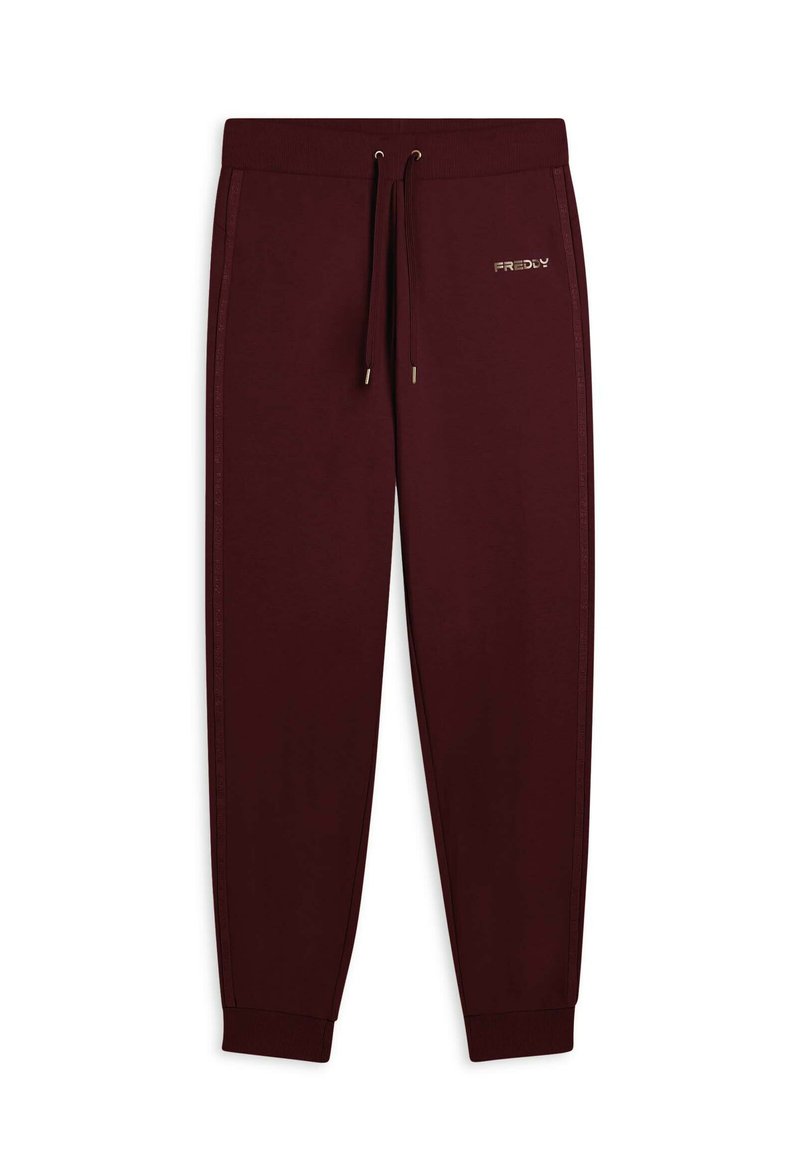Pantaloni della tuta color marsala realizzati in tessuto morbido, con vita elastica e cordoncino, righe laterali e un piccolo dettaglio in oro.