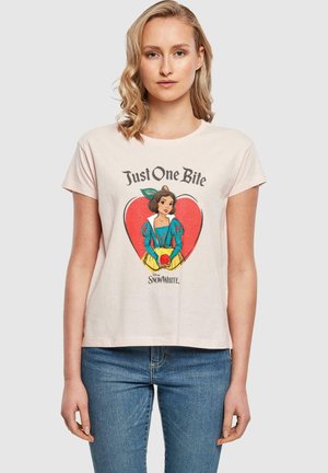 Light pink cotton t-shirt featuring a graphic of Snow White with the text "Just One Bite" inside a red heart. Short sleeves, relaxed fit.