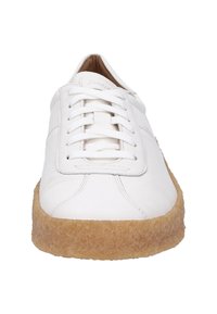 Weiße Ledersneaker mit abgerundeter Zehenpartie, flachen Schnürsenkeln und einer strukturierten, beigen Gummisohle. Sauberes Design mit dezenten Steppnähten.