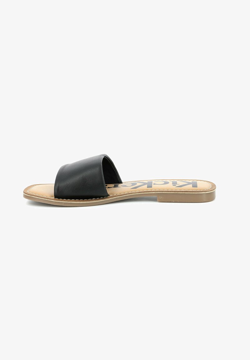 Black leather slide sandal with a wide strap, flat sole, and beige insole. Features stitching detail along the edges and a minimalist design.