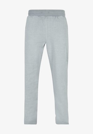 Pantaloni della tuta grigio chiaro realizzati in tessuto morbido, dotati di una vita elastica e tasche laterali. Tessuto liscio con design a gamba affusolata.