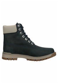 Bottine noire et beige avec laçage devant, col matelassé et semelle épaisse crantée pour une utilisation en extérieur ou au travail.