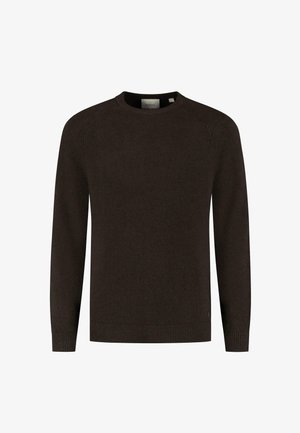 Rudas megztinis su apykakle, ilgomis raglan rankovėmis ir apsiūtomis rankogaliais ir hemu. Paprastas dizainas, be matomų raštų ar akcentų.