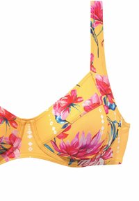 Gul blommig behå med underwire och mönster av rosa och blå blommor. Har breda band och en strukturerad design för stöd.