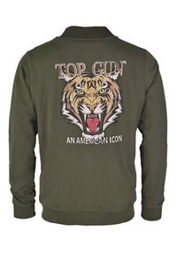 Oliwkowy sweatshirt z grafiką tygrysa z wyrazistym detalem, tekstem "TOP GUN" oraz napisem "IKONA AMERYKAŃSKA" wydrukowanym poniżej.