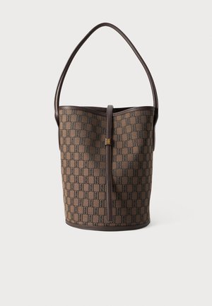 Bucket bag in brown monogram canvas with a smooth leather trim, featuring a single shoulder strap and a gold-tone hardware detail.