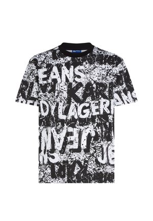 T-shirt noir et blanc col rond avec un motif de peinture éclaboussée et un grand texte en gras superposé comprenant "KARL" et "JEANS".