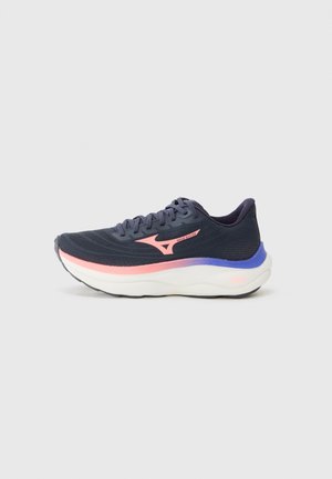 Navy running shoe with a mesh upper, pink and purple accents, a thick white midsole, and textured outsole for grip. Laces and logo detail visible.