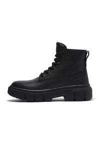Black ankle boots made of smooth leather with a padded collar, lace-up design, thick sole, and a loop tab on the back for easy wear.