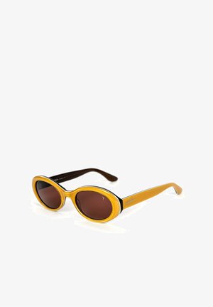 Yellow oval sunglasses with brown lenses, featuring a black accent around the frame and a glossy texture. Side engraved logo detail.