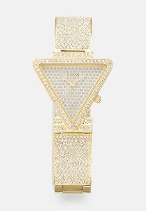 Goldfarbene Uhr mit dreieckigem Zifferblatt, verziert mit klaren Kristallen und einem strukturierten Armband, ausgestattet mit einem minimalistischen Ziffernblatt und einem Logo in der Mitte.