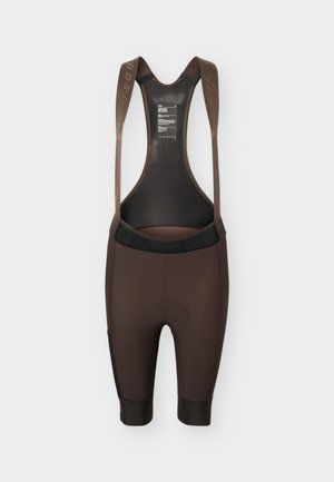 Smeđe biciklističke kratke hlače s crnim mrežastim stražnjim panelom i naramenicama, dizajnirane za sportsku upotrebu.