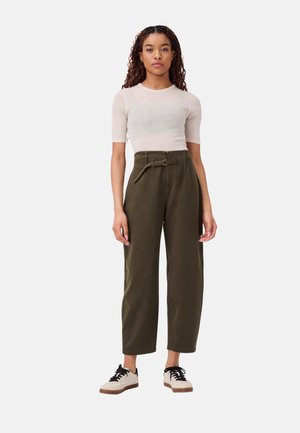 Olive green high-waisted pants with a belt, featuring wide legs and a smooth texture. Paired with a light beige short-sleeve top.