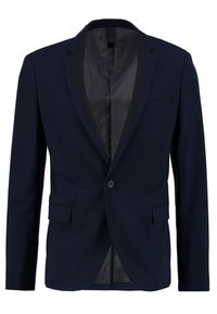 Mörkblå kavaj med en enda knappstängning, slagkrage, två framfickor och en slät innerfoder. Skräddarsydd passform och strukturerad design.