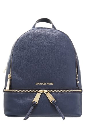 Granatowy skórzany plecak Michael Kors z złotymi zamkami i logo, wyposażony w dwa suwaki i górną rączkę.