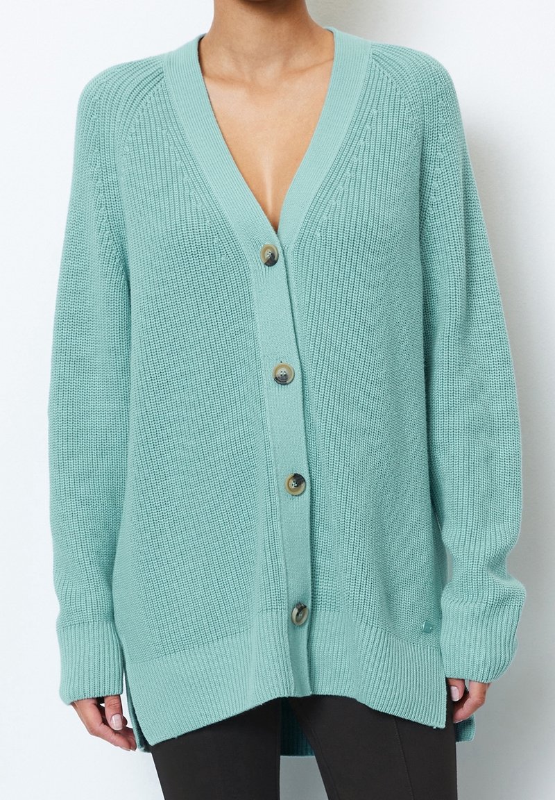 Mint green cardigan featuring a deep V-neck, chunky knit texture, five buttons down the front, and ribbed cuffs and hem.