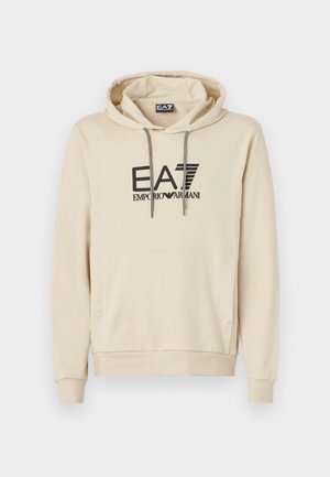 Beige hoodie made of soft fabric, featuring a front pocket, adjustable drawstring hood, and a bold black logo on the chest.