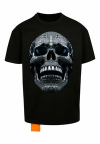 Black t-shirt featuring a large graphic of a skull, detailed with metallic accents, varying textures, and a bright orange label on the side.