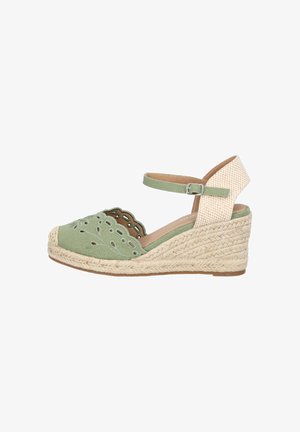 Groene canvas wedge espadrille met uitgesneden bloemenpatronen, jute touwzool en een beige enkelband. Traditioneel ontwerp met een zachte textuur.