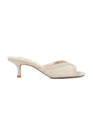 Beige open-toe heeled mules with a textured upper featuring rhinestone embellishments, a curved design, and a slender stiletto heel.